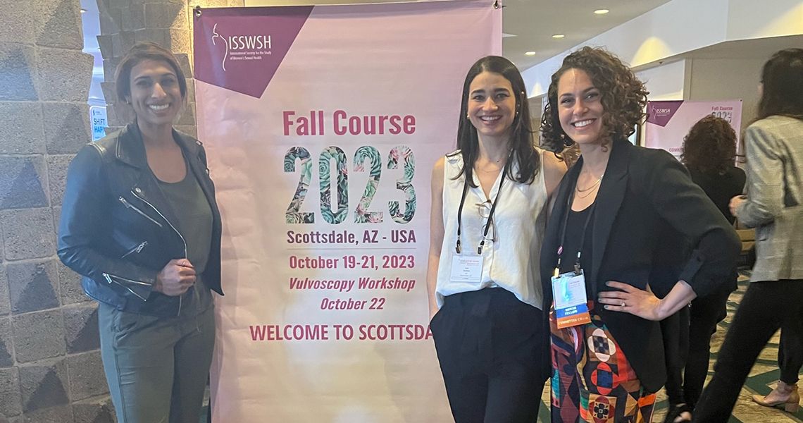 Fellows with Dr. Cigna in front of a banner that says "Fall Course 2023"